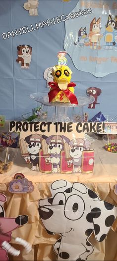 a table topped with lots of cake covered in frosting next to a sign that says protect the cake