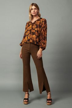 This blouse feels so right for the season, done in a vintage-esque burnt orange floral print on a dark background. It's relaxed and airy, designed with semi-sheer layers and featuring a V-shaped neckline, long sleeves, and ruffle trim traced by picot stitching.•Popover style •V-neckline •Long sleeves •Picot-stitched ruffle trim •Relaxed fit DIMENSIONS •Standard: 24" LengthItem number 2230268100% Polyester Semi-stitched Designer Blouse, Luxury Orange Semi-stitched Blouse Piece, Embroidered V-neck Semi-stitched Blouse, Orange Embroidered Semi-stitched Blouse Piece, Luxury Semi-stitched Orange Blouse Piece, Orange Printed V-neck Blouse, Fall Paisley Print V-neck Blouse, Ruffle Trim, Burnt Orange