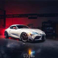 a white sports car parked in a garage