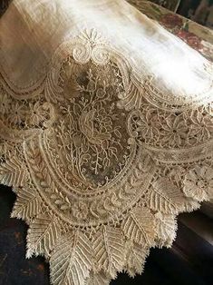 an old table cloth with lace on it