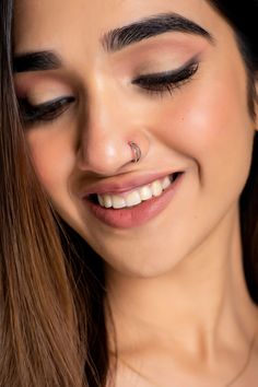 a close up of a person with a nose ring