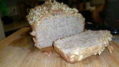 a loaf of bread sitting on top of a wooden cutting board