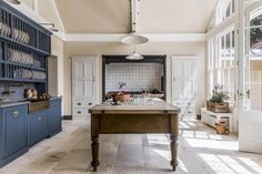 a kitchen with blue cabinets and an island