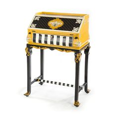 an antique yellow and black striped desk with drawers on the top, sitting against a white background