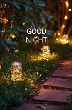 the words good night are lit up in mason jars with fairy lights on them and grass