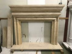 an old fireplace is being worked on in a shop