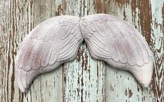 an image of a pair of wings on wood