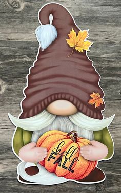 an image of a gnome with pumpkins in his hand and the words fall on it