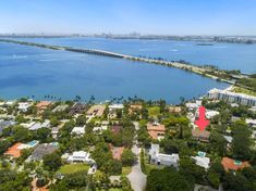 an aerial view of a large body of water with houses and trees in the foreground