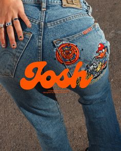 a woman's jeans with patches on them and the word boo written in orange