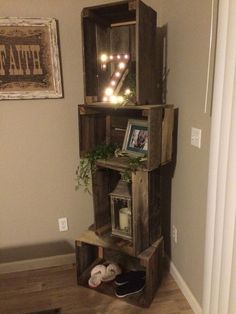 a shelf made out of wooden crates with lights on top