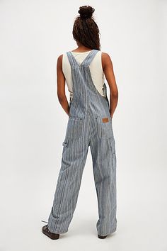 So fun in stripes, these overalls from Wrangler will turn heads with every wear. **Fit:** Relaxed, classic bib and brace silhouette **Features:** Adjustable brace straps, front functional bib pocket, yarn-dyed striped fabrication, soft rigid denim **Why We ❤ It:** Classic with cowgirl boots or off-duty with sneakers, you’ll reach for these from this season to the next. | Wrangler Stripe Straight-Leg Bib Overalls at Free People in Dark Wash, Size: XS Striped Cotton Overalls, Casual Striped Overalls With Pockets, Striped Overalls, Jean Overalls, Bib Overalls, Dungarees, Cowgirl Boots, Off Duty, Yarn Dyeing