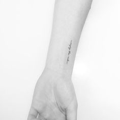 a person's hand with a small tattoo on the wrist that says, i love you