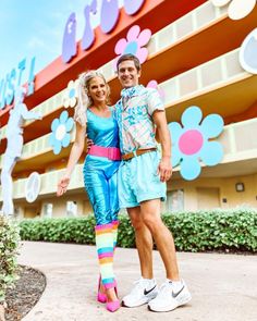 a man and woman standing in front of a building