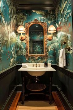 a bathroom with green and gold wallpaper, a mirror, sink and two lamps