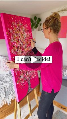 a woman is painting on an easel with the words i can't decide