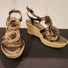 Wow! Beautiful Bronze Leather Floral Sandals By Strictly Comfort In New Never-Worn Condition Without Tags. - Bronze Metallic Leather Uppers - Super Padded Footbed - Cute Formed Leather Flower Front Detail - Buckle Ankle Strap - 1 1/2" Platform 3 1/2" Burlap Wrapped Wedge Heel - Rubber Outsoles - Condition...New Never-Worn Condition Without Tags Or Box. No Scuffs Or Defects Visible. Please See Pics For Condition - Non-Smoking Home - Quick Ship Seller With A 5-Star Rating I Welcome Reasonable Offe Elegant Brown Wedge Sandals For Spring, Elegant Brown Wedge Sandals For Vacation, Floral Wedges, Floral Sandals, Leather Flower, Leather Floral, Leather Flowers, Star Rating, Metallic Leather