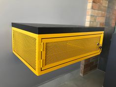 a yellow and black cabinet hanging on the wall