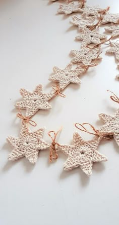 crocheted star garland with twine on white table top, ready to be used as decoration