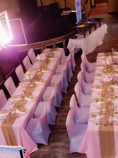 the tables are set with pink and gold linens