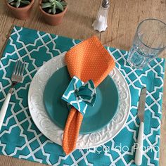 the place setting is ready to be served for two people at this dinner table, with succulents and napkins