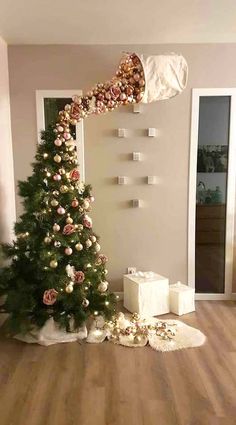 a decorated christmas tree sitting in the middle of a living room with presents on the floor