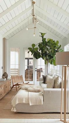 a living room filled with furniture and a flat screen tv mounted to the side of a wall