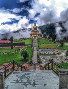 a large building sitting on top of a lush green hillside