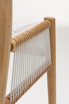 a close up of a wooden chair with white fabric on it's backrest