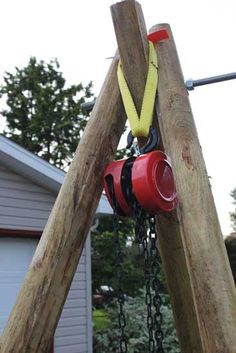 a wooden structure with chains and buckets hanging from it