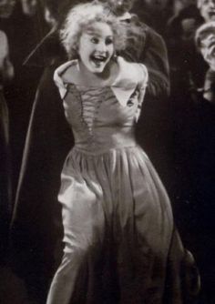 an old black and white photo of a woman dancing