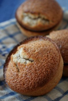 three muffins sitting on top of a blue and white checkered cloth