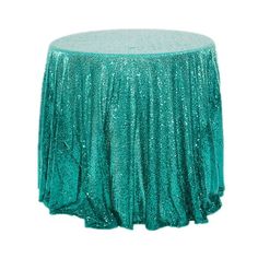 a green sequin tablecloth on top of a round table with a white background