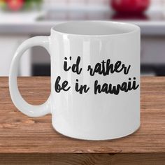 a white coffee mug with the words i'd rather be in hawaii on it