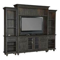 a large entertainment center with a flat screen tv on it's side and shelves