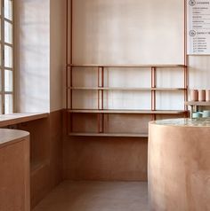 an empty room with shelves and candles on the counter