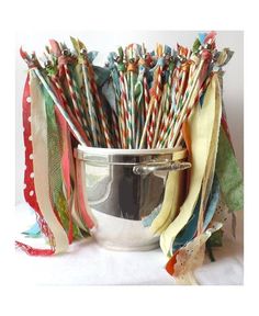 a metal bowl filled with lots of colorful striped straws