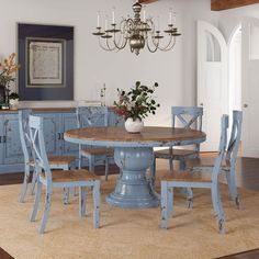 a dining room table with chairs and a chandelier