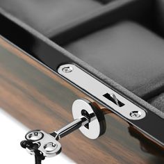 a close up view of the inside of a wooden case with metal handles and latches