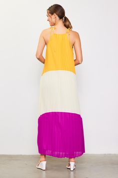 A breezy maxi dress is a must-have in hot weather, and this colorblocked version demands attention. It's bold, fun, and flowy, designed with a shoulder-baring halter neckline, dainty ties, and a cascade of pleats. •Halter neckline with self-ties •Front cutout •Pleated Item Number: 99171 Color Block Maxi Dress, Halter Neckline, Hot Weather, In Hot, Item Number, Color Block, Must Haves, Maxi Dress, Color