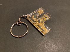 a keychain that has been made to look like a piece of gold leaf