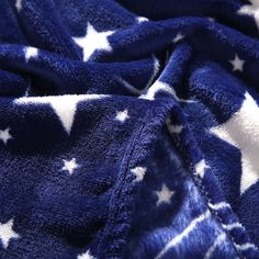 a blue and white blanket with stars on it's side, folded up to show the fabric