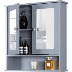 the medicine cabinet is gray and has two mirrors on it, one door open to reveal its contents