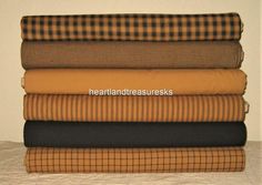 four different plaid fabrics stacked on top of each other in various colors and patterns,