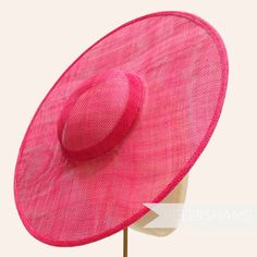 *This is not a fitted hat! You will need to attach a headband, comb or elastic to secure it to your head* This fuchsia pink cartwheel hat base is a classic shape that has sprung into popularity in the past year. Made from 2 layers of stiffened sinamay, these cartwheels are ready to trim and are fitted with a petersham ribbon on the inside crown edge. Simply add a comb or headband to secure to the head. Hat base measures: Width: 35.5cm (14 inches) Crown Width: 13.5cm (5.3 inches) Crown Height: Approximately 3.5cm (1.7 inches) In this listing we give you the option of attaching an elastic, this is to help secure the fascinator base to your head as it is not a fitted/finished headpiece. If you would prefer to use a headband or a comb, these can be purchased separately in our shop for you to s Pink Sinamay Hat For Spring, Fitted Hats With Pinched Crown For Summer, Fitted Summer Hats With Pinched Crown, Pink Structured Crown Hat For Kentucky Derby, Pink Adjustable Fascinator With Pinched Crown, Fitted Summer Hat With Pinched Crown, Pink Adjustable Fascinator With Short Brim, Pink Mini Hat With Pinched Crown For Summer, Adjustable Pink Fascinator For Church