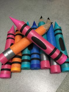 there are many different colored crayons and one has a pencil in the middle