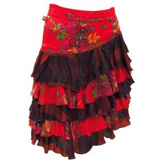 This ultra feminine red floral satiny soft skirt comes from vintage Jean Paul Gaultier. A fitted waist with side zip falls to tiered layers of sheer black mixed with red florals. Red Summer Skirt With Attached Cancan, Summer Skirt With Attached Cancan In Red, Summer Red Skirt With Attached Cancan, Vintage Red Tiered Skirt, Red Vintage Tiered Skirt, Red Asymmetrical Skirt With Ruffles, 2000s Skirt, Vintage Jean Paul Gaultier, Soft Skirt