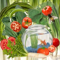 a fish bowl filled with lots of different types of vegetables next to plants and flowers