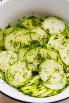 cucumber slices and herbs in a white bowl