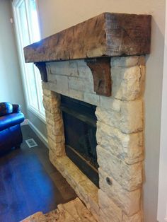 a stone fireplace in the corner of a living room